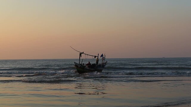 A wooden fishing boat heads out to sea in search of fish at dusk.
