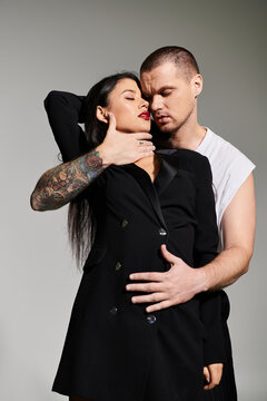 A young couple embraces passionately in a chic studio, capturing romance.