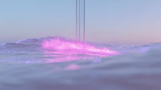 Rising ocean crest at water level facing camera, pink star beams striking, making pink foam