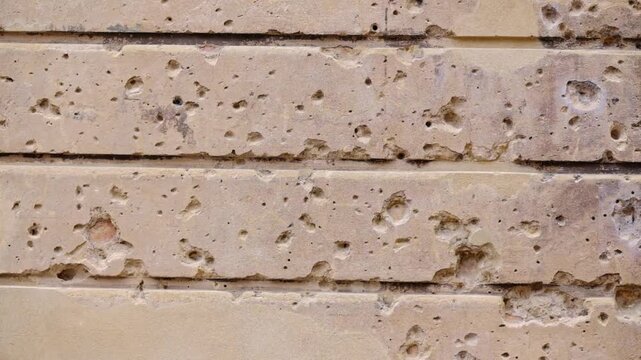 Wall in Berlin full of bullet holes from the war