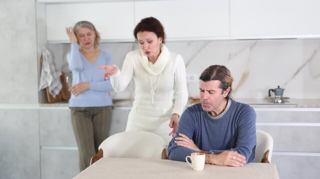 Wife and mother swear at man who puts up with it while sitting at kitchen table