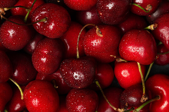 Fresh sweet cherries with water drops macro background texture