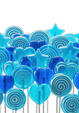 hyper-glossy electric blue lollipops and hard candies in various shapes, tightly grouped with fine sugar details, macro studio shot against a transparent background. concept for confectionery