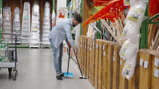 Man sweeping floor in a large hardware store
