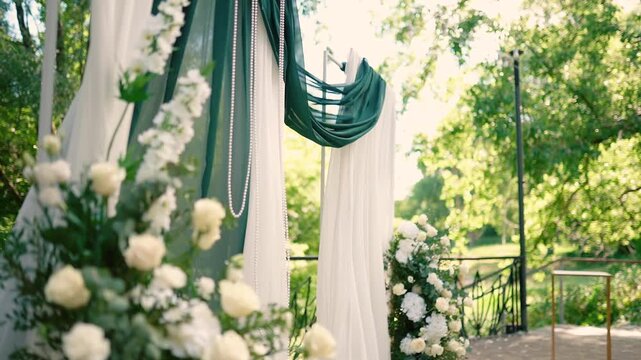 wedding arch of white rose flowers on the river bank before the wedding ceremony of the bride and groom, festive romantic decor
