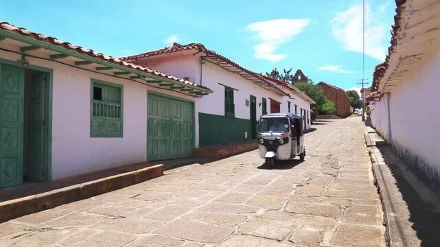 Tuk tuk traveling through the streets of Bartichara Santander Colombia