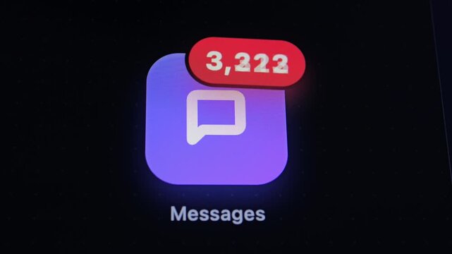 A close-up of a purple chat app icon on a dark screen with a red notification badge showing high counts of unread messages.