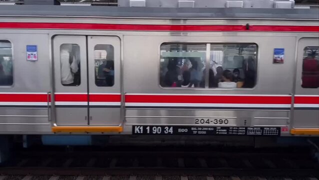 Watching a Passenger Train Pass Through a Railway Station