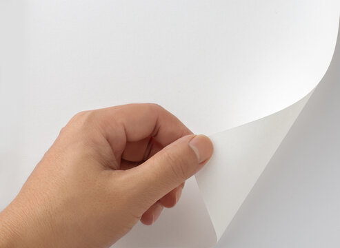 Close-Up of Hand Peeling and Turning Blank White Page Mockup