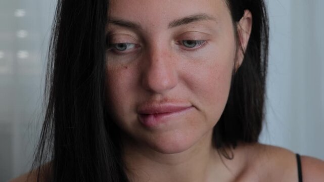 Social anxiety and emotional suppression concept with woman biting lips in close up, nervous discomfort and hidden emotions behavior