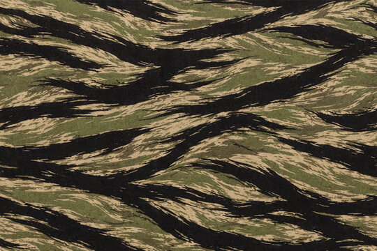 Tiger stripe all-terrain camouflage seamless fabric texture with bold diagonal slash marks in forest green, black and khaki on ripstop nylon, Vietnam era revival