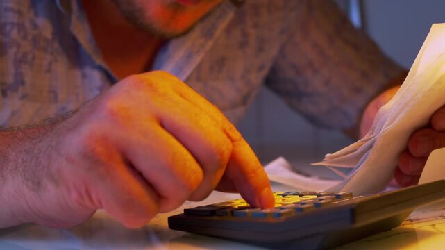 Cinematic close-up shot of evaluating personal finances under a lamp light. Defocused background. Visualizes family expense audit, budget optimization, money saving, cost cutting.