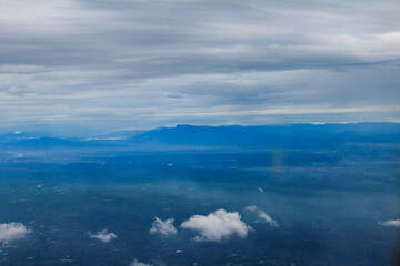 Aerial View of Mountain Range Under Layered Clouds © TranAnhDao