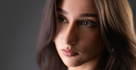 Fototapeta premium Female model looking away, showing elegance and natural beauty