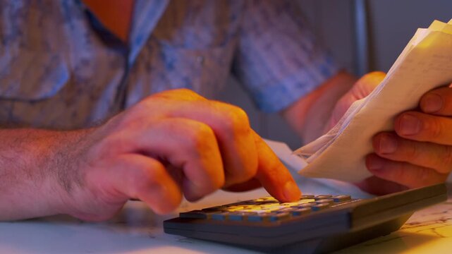 Cinematic close-up shot of evaluating personal finances under a lamp light. Defocused background. Visualizes family expense audit, budget optimization, money saving, cost cutting.