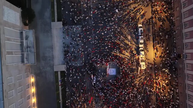 Vertical Night Drone View of Protest Crowd and Street Lighting