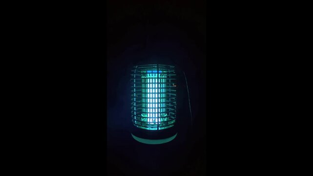 A mosquito zapper at night in full glow