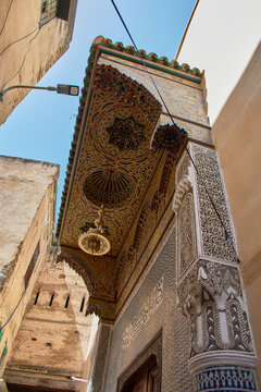 Traditional zellige mosaics decorate the carved wooden porch of the mystical Zawiya of Sidi Ahmed al-Tijani.