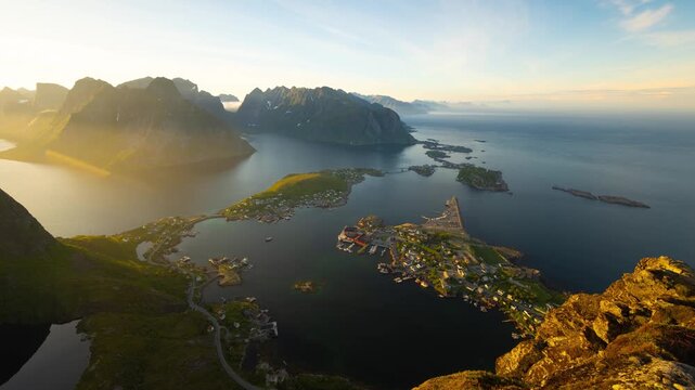 Time lapse of the midnight sun and the ocean, mountains and town of Reine along the amazing coast of Northern Norway.