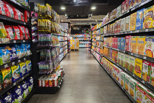 Bayan Lepas, Malaysia - May 14, 2026: A well-stocked supermarket aisle displaying breakfast cereal boxes and milk powder products on shelves at a Mercato store.