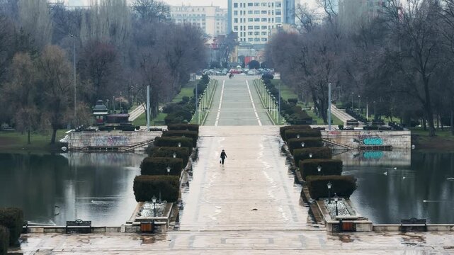 Woman Walking Towards Tomb of Unknown Soldier in Carol Park, Bucharest