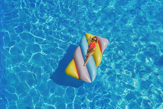 Child in swimming pool. Having fun on vacation at the hotel pool. Colorful vacation concept.