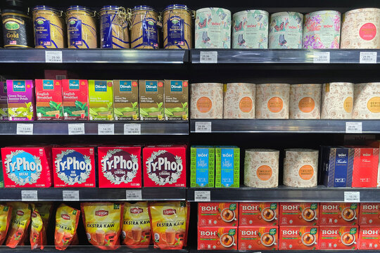 Penang, Malaysia - May 14, 2026: Retail display shelves filled with an assortment of premium tea boxes and decorative tins, including BOH, Dilmah, and Ty.Phoo brands at a Mercato supermarket.