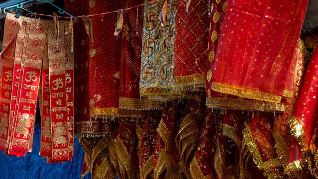 sacred red and golden chunris and devotional cloths at Kamakhya temple with inscriptions of jai maa Kamakhya devi 1