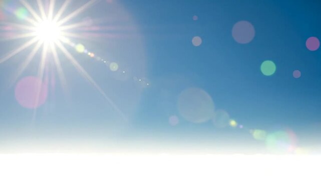 Bright sun shining in a clear blue sky with lens flare