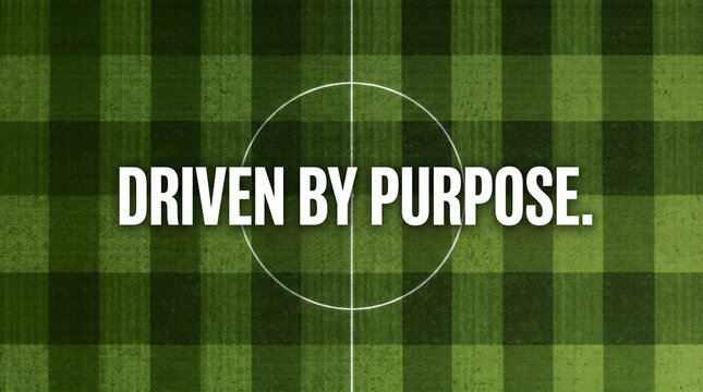 Overhead view of green soccer field with driven by purpose text