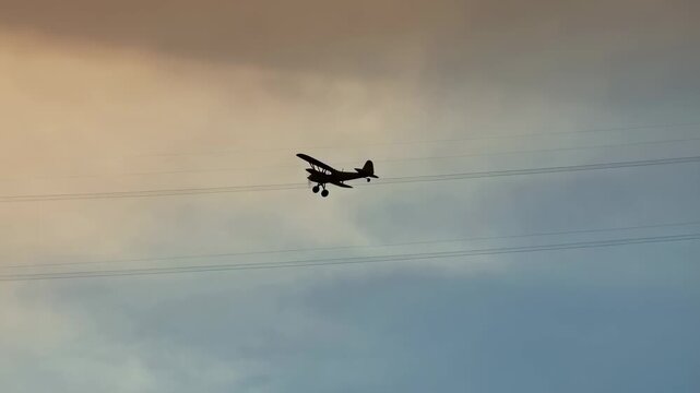 Vintage biplane flying against a colorful sunset sky. A nostalgic representation of aviation and adventure in the open air