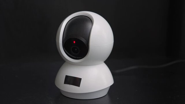 High-quality sound recording in uncompressed WAV format of a smart security camera starting up, turning from side to side with audible small electric motors for Foley, editing, and audio library use.