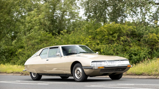 Stony Stratford,Bucks,UK - June 7th 2026:  1973 Citroen sm classic car driving on a British road