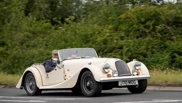 Stony Stratford,Bucks,UK - June 7th 2026: 1992 cream Morgan Plus 4 car driving on a British road