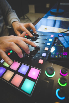Music Producer Using MIDI Controller and Faders in Studio