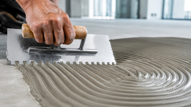 Applying Tile Adhesive with Notched Trowel &ndash; Professional Flooring Installation and Renovation Work