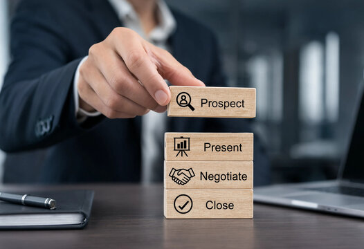 Hand stacking wooden blocks with sales process steps prospect