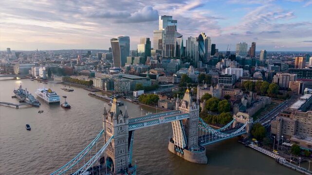 Aerial hyperlapse view of the Tower Bridge in London, England, lifting open for ship traffic during sunset time