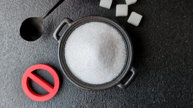 The sugar ban sign as a concept to stop the problem of diabetes and obesity, a call to diet. The sugar ban sign as a background for your design