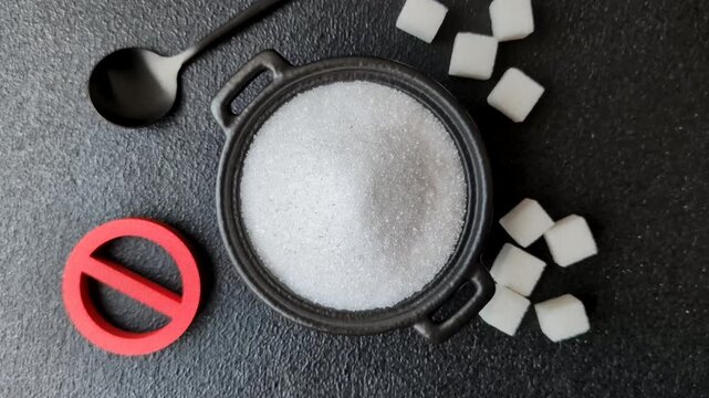 The sugar ban sign as a concept to stop the problem of diabetes and obesity, a call to diet. The sugar ban sign as a background for your design