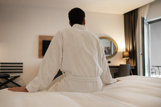 Guest Sitting on Bed from Behind