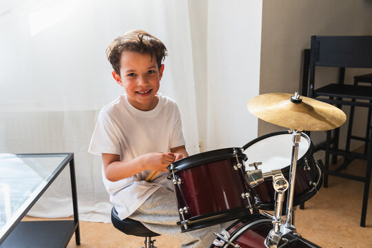 Portrait of a happy young boy with drums