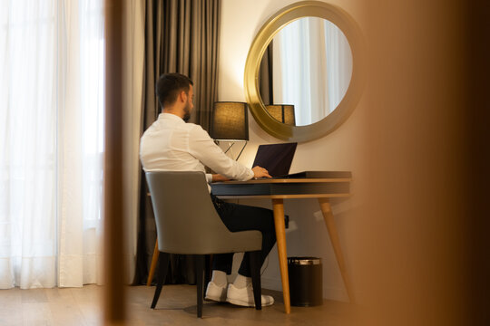 Working on Laptop at Hotel Desk