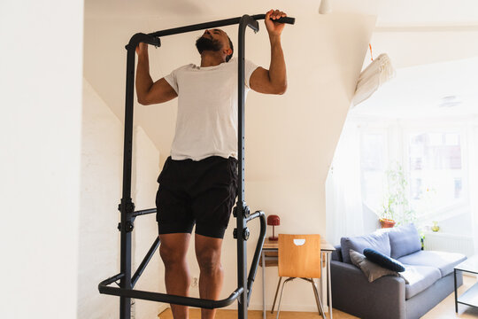 Close-up front view of a man doing a pull up
