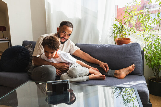 Father and son bonding while watching smartphone