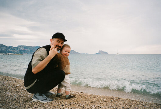 Portrait of a father and baby on the beach