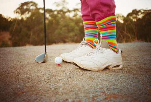 Person  Prepares to Hit Golf Ball on Country Golf Course 