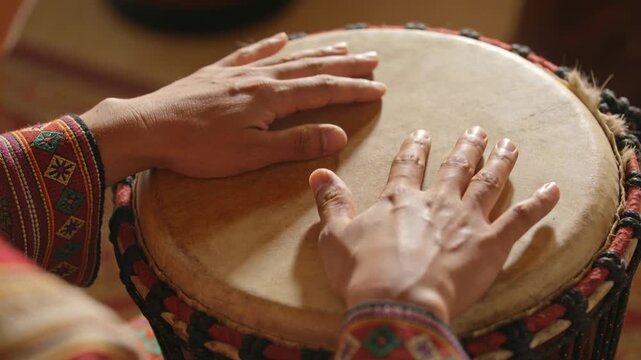 Starting from resting palms musician hands moving tapping rolling on drumhead at home woven cuff