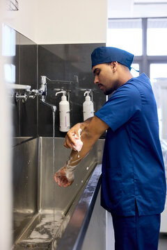 Doctor Washes Hands in Hospital Before Patient Care