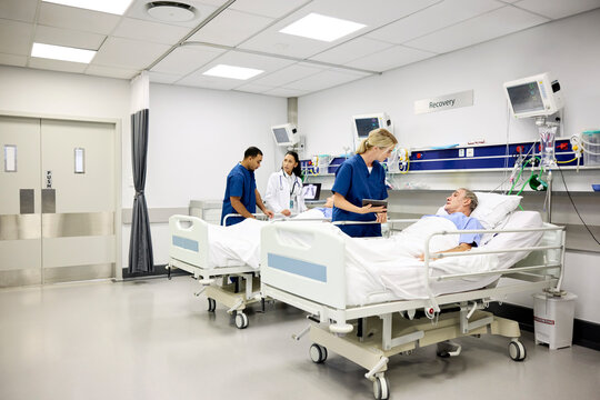 Medical Team Assists Patients in Hospital Recovery Room